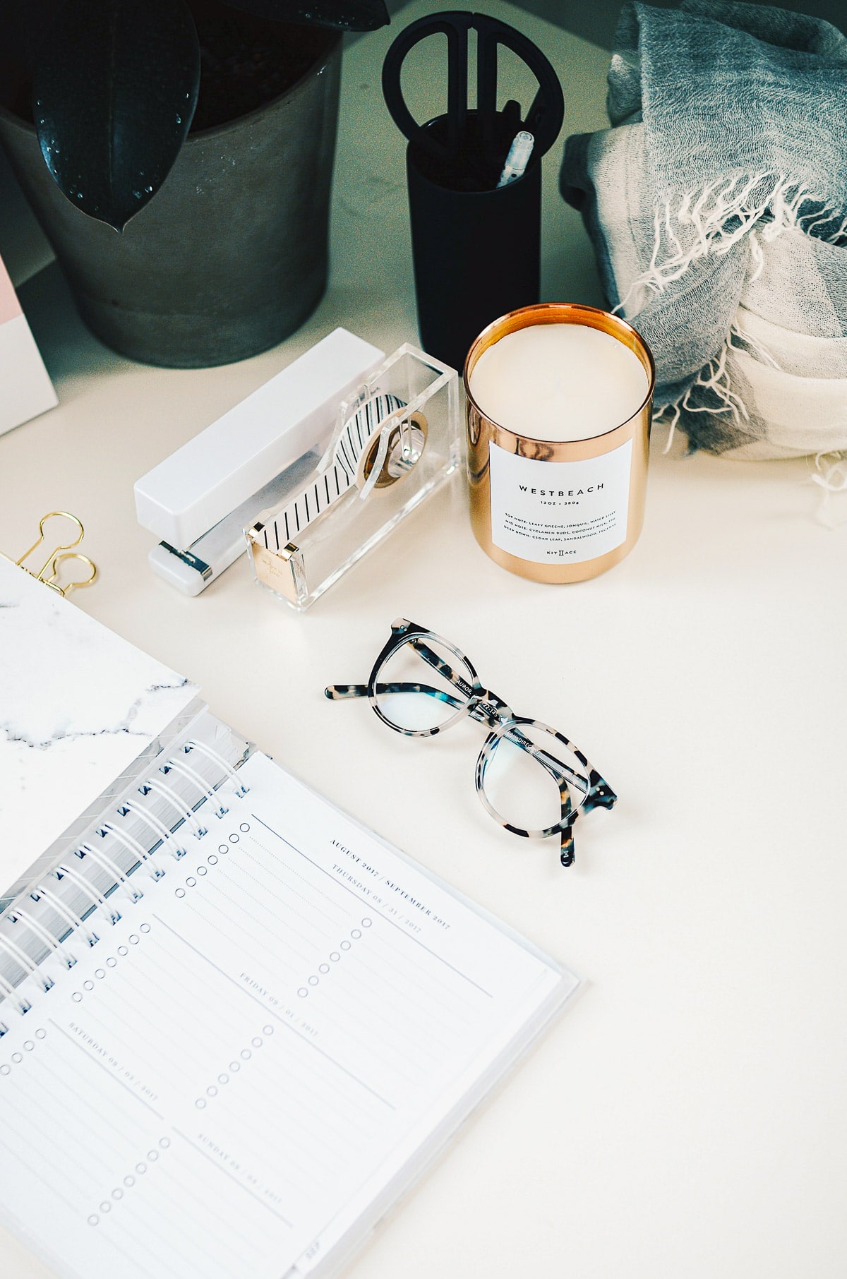 Desk with a calendar, glasses and office supplies