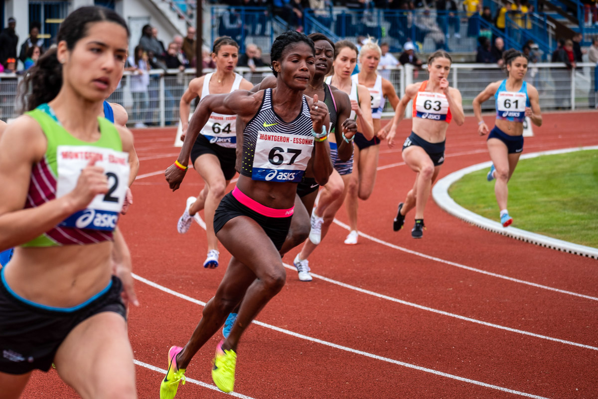 Women running on a track competing with each other