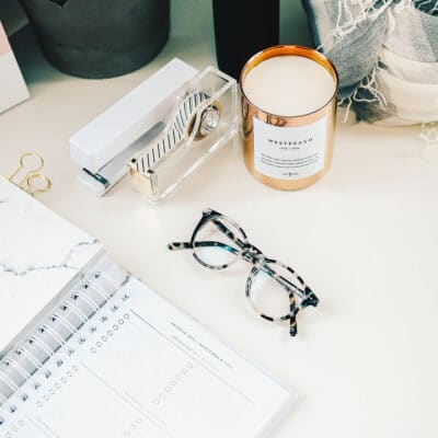 A table with a calendar, glasses and office tools - square