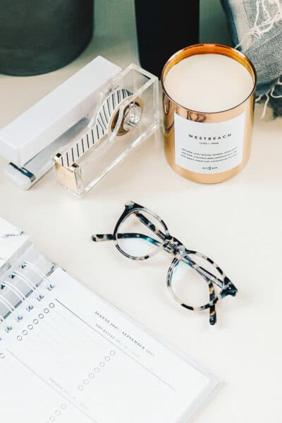 A table with a calendar, glasses and office tools - square