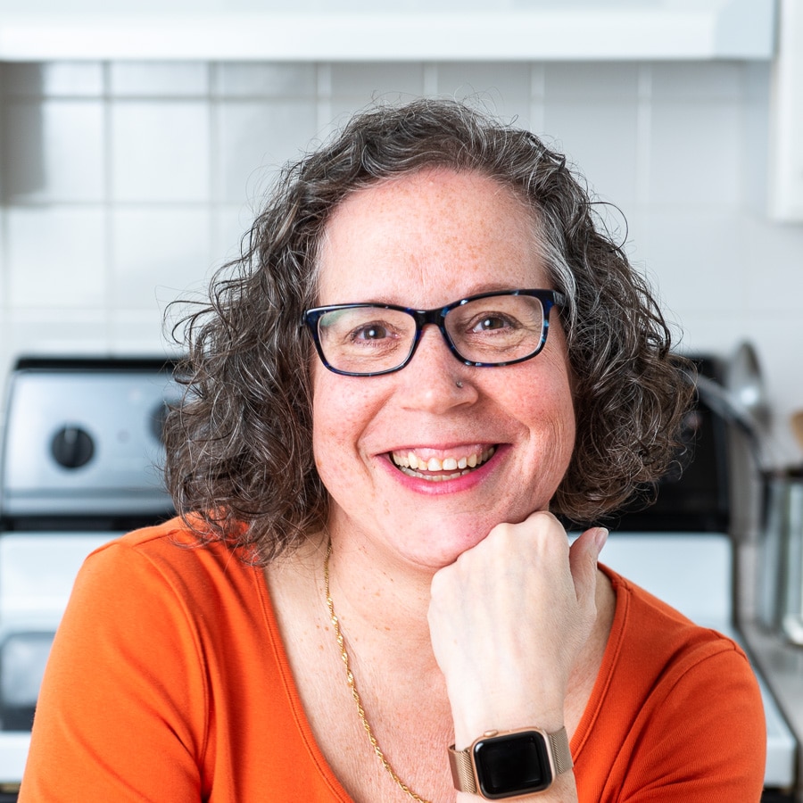 Elaine with an orange shirt and glasses