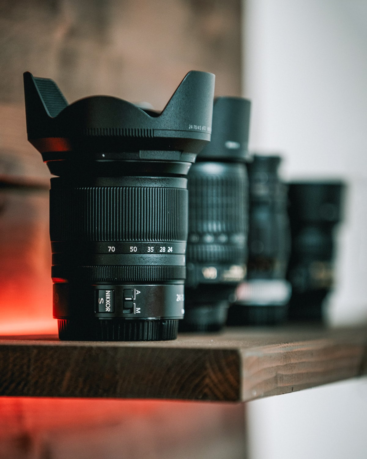 Four lenses on a wooden shelf