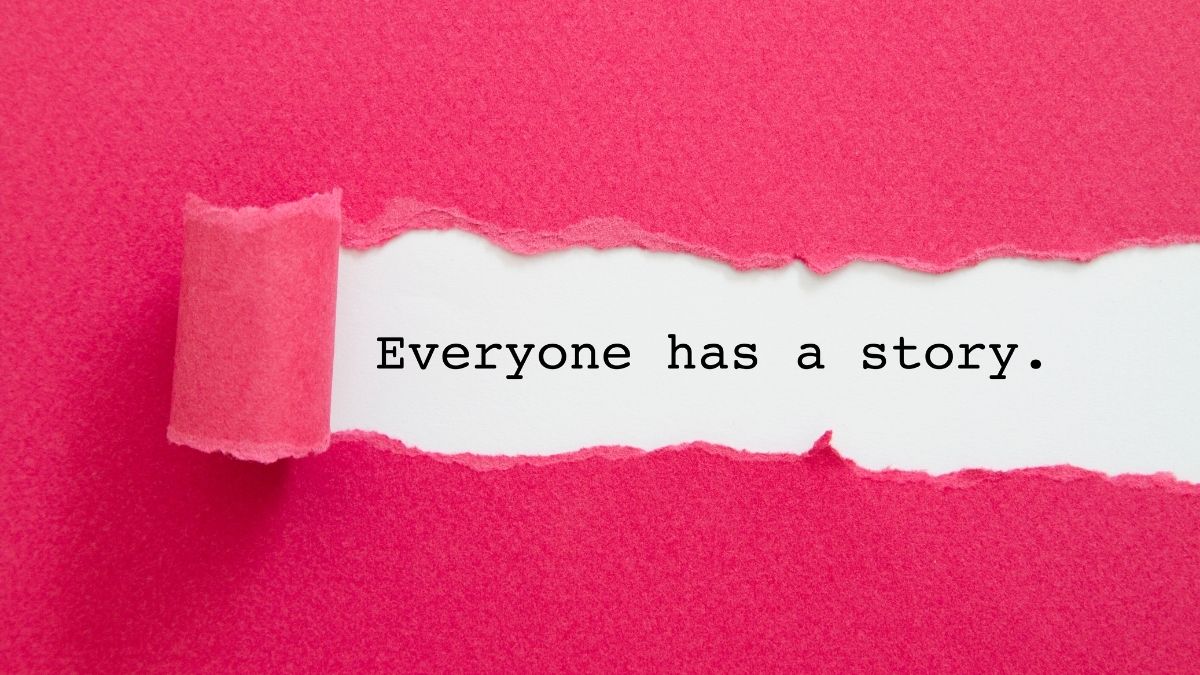 The words 'everyone has a story' being revealed through a rip in red paper