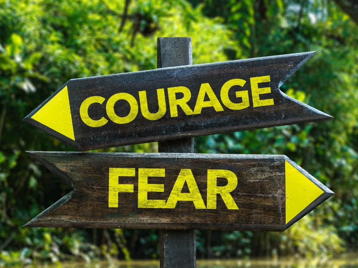 Arrow signs that say courage and fear