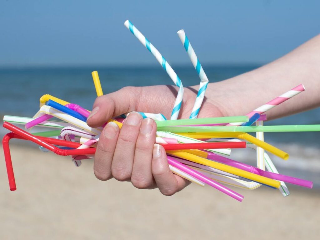 hand holding an assortment of straws