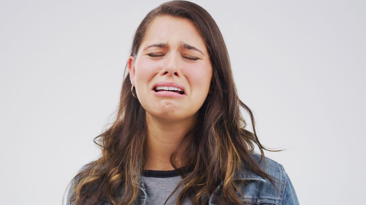 A woman with brown hair crying