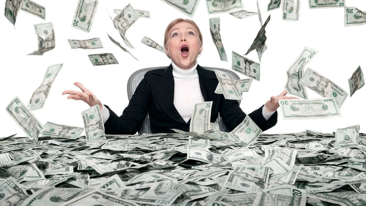 Money raining on a woman in a black suit
