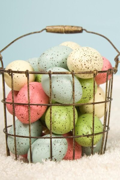 Colored eggs in a wire basket